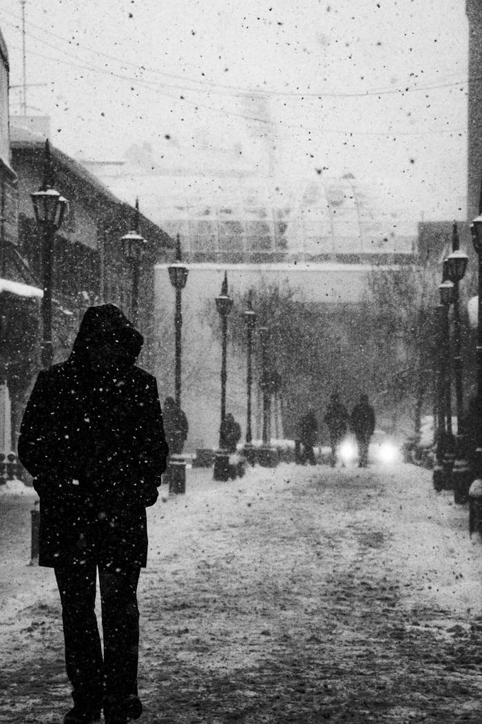 services-02 Silhouette of a person in a snowy street in Eskişehir, capturing a moody winter atmosphere.