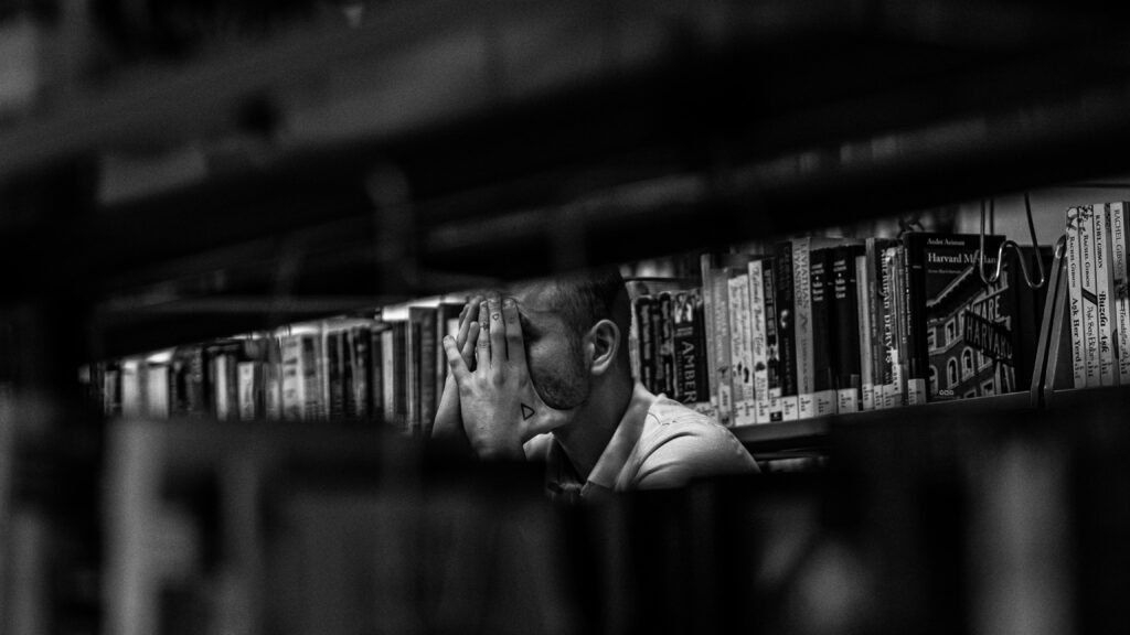 A contemplative moment captured in a university library setting.